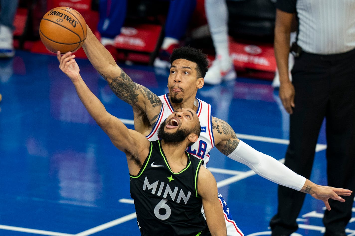 Philadelphia 76ers' Danny Green, right, blocks a shot attempt by the Timberwolves' Jordan McLaughlin, left, during the second half