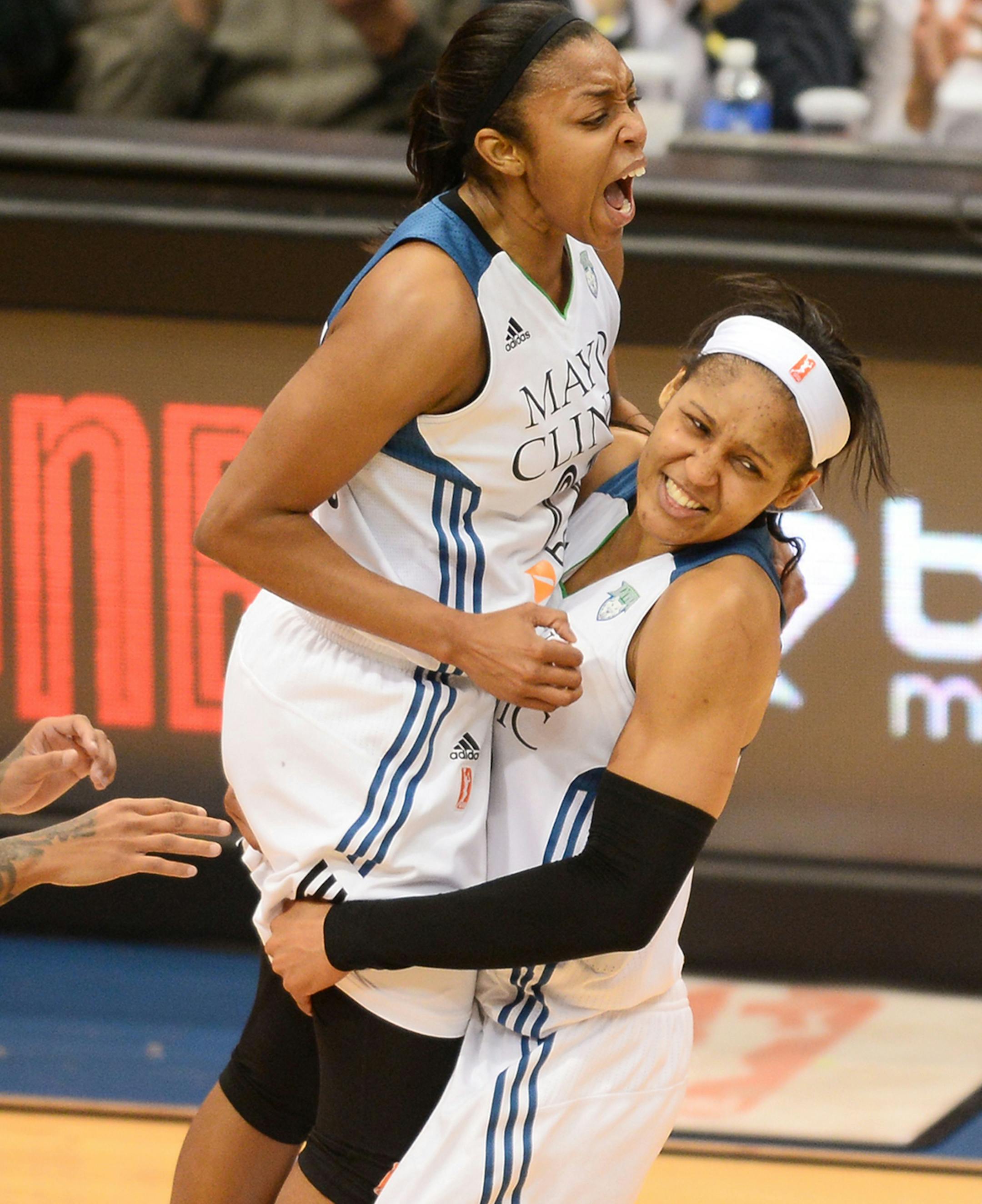 Minnesota Lynx guard Renee Montgomery (21), left, celebrates with Minnesota Lynx forward Maya Moore (23) after making a last second steal and basket at the end of the third quarter.