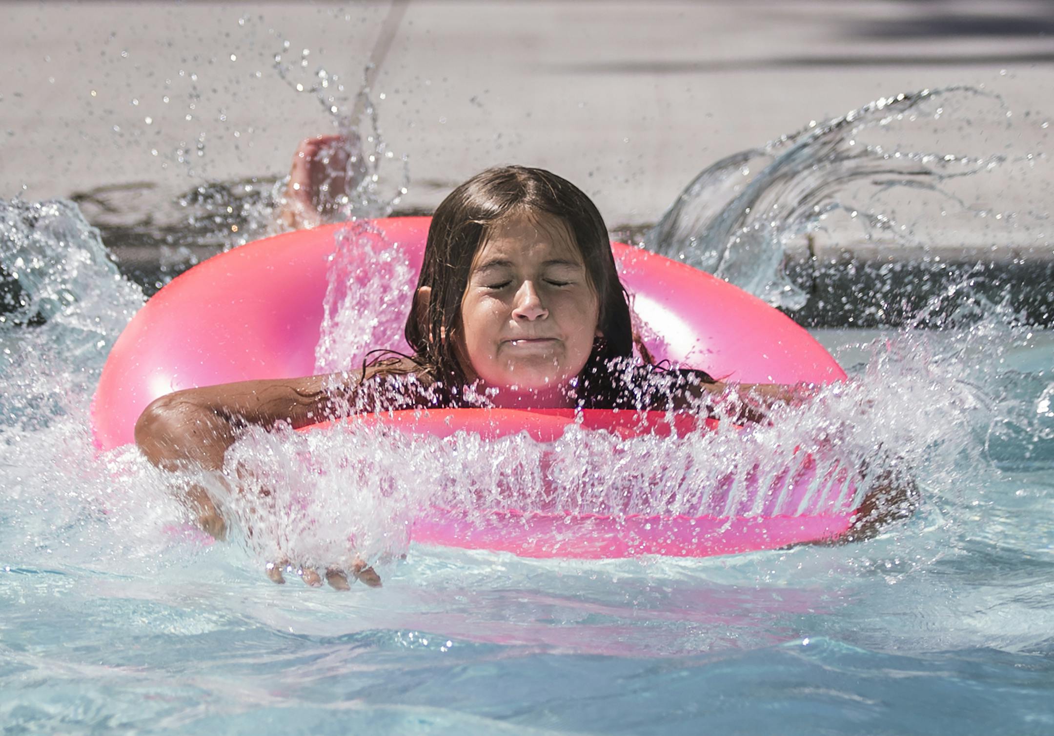 Alissa Hernandez, 8, of Minneapolis jumps into the wading pool at Van Cleve Park. ] (Leila Navidi/Star Tribune) leila.navidi@startribune.com BACKGROUND INFORMATION: Van Cleve Park in Minneapolis on Monday, August 15, 2016. Wading pools are open 10 am-9 pm daily May 28-September 5, 2016. The weather was perfect for swimming, pleasant with sunshine and patchy clouds and a high of 83 F.