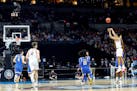 Jalen Suggs (1) of the Gonzaga Bulldogs shoots a game-winning three-point basket in overtime to defeat the UCLA Bruins 93-90 during the 2021 NCAA Fina
