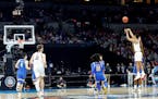Jalen Suggs (1) of the Gonzaga Bulldogs shoots a game-winning three-point basket in overtime to defeat the UCLA Bruins 93-90 during the 2021 NCAA Fina