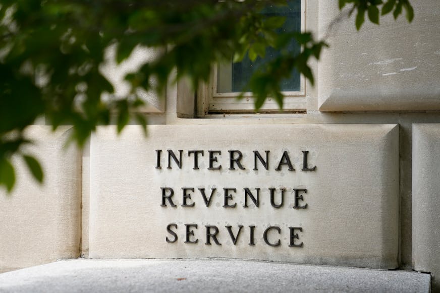 FILE - A sign outside the Internal Revenue Service building is seen, May 4, 2021, in Washington.