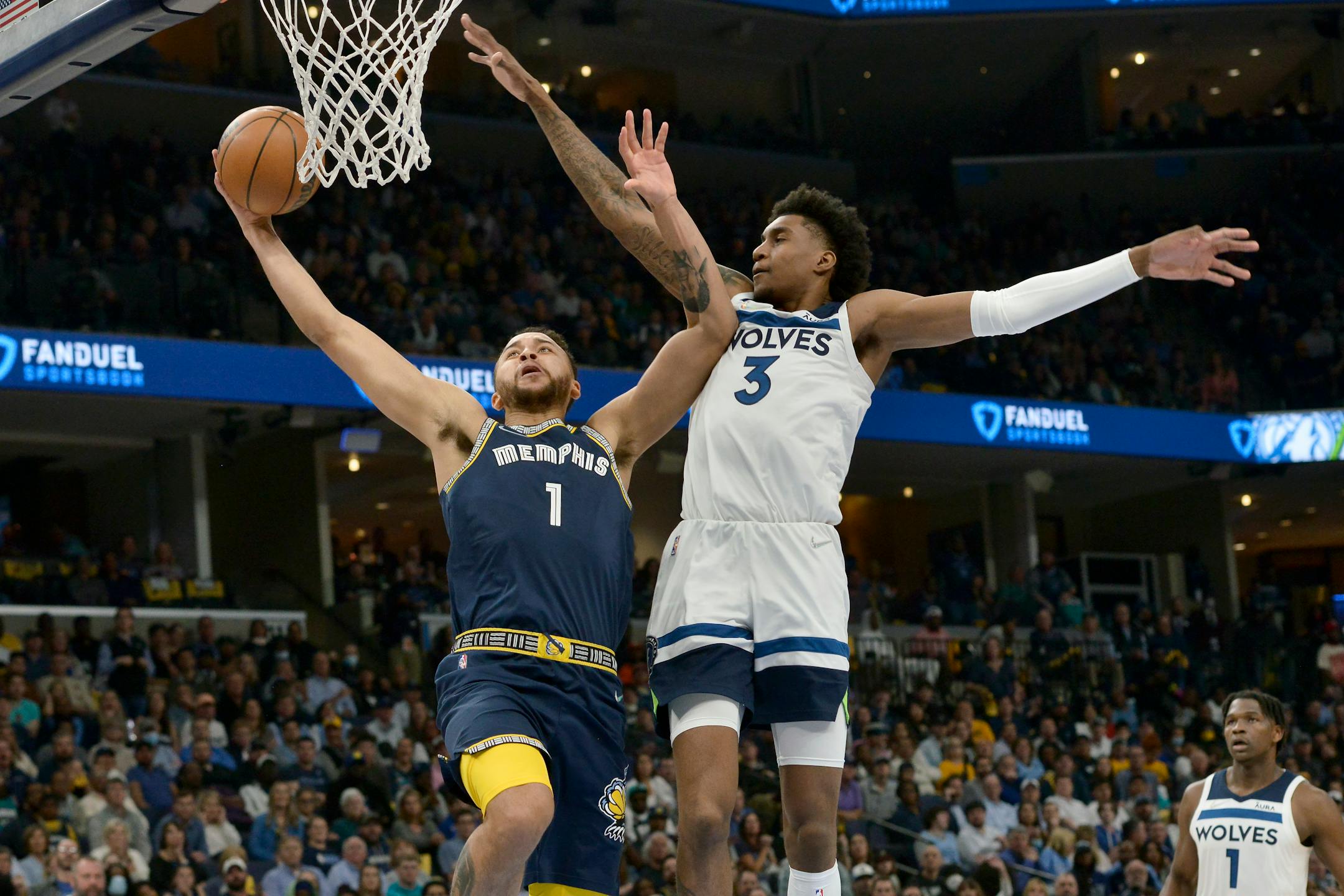 Memphis Grizzlies forward Kyle Anderson (1) shoots against Minnesota Timberwolves forward Jaden McDaniels (3) during the first half during Game 2 of a first-round NBA basketball playoff series Tuesday, April 19, 2022, in Memphis, Tenn. (AP Photo/Brandon Dill)