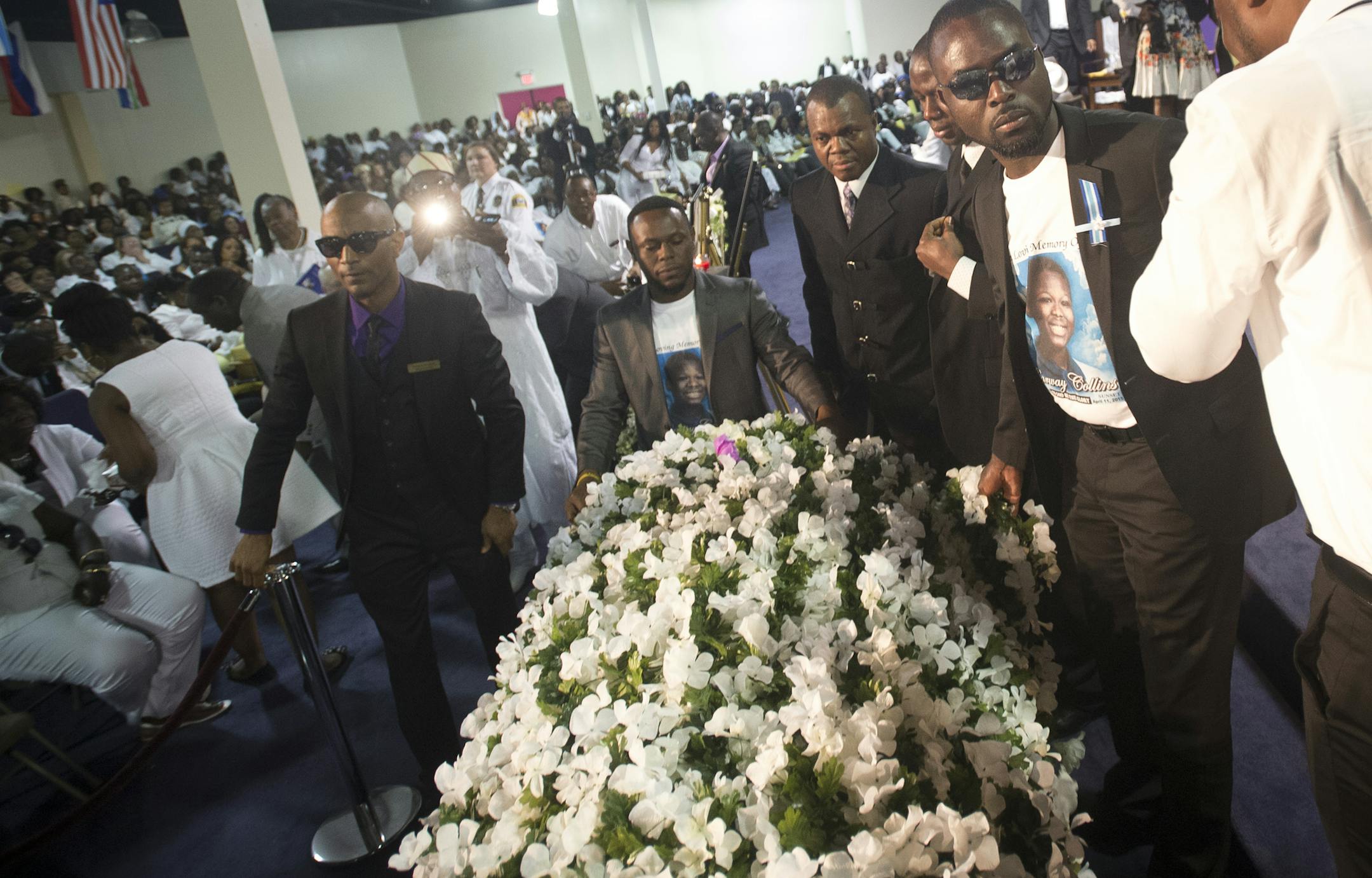 Members of the Collins family drape Barway's casket with a blanket of flowers during Barway's funeral on Saturday afternoon. ] (Aaron Lavinsky | StarTribune) aaron.lavinsky@startribune.com The funeral of 10-year-old Barway Collins was held Saturday, May 2, 2015 at Shiloh Temple in north Minneapolis.