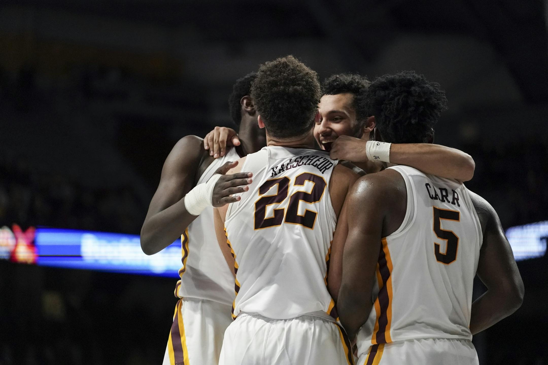 Teammates celebrated with Minnesota Gophers guard Gabe Kalscheur (22) after he stole the ball from Maryland in the second half.