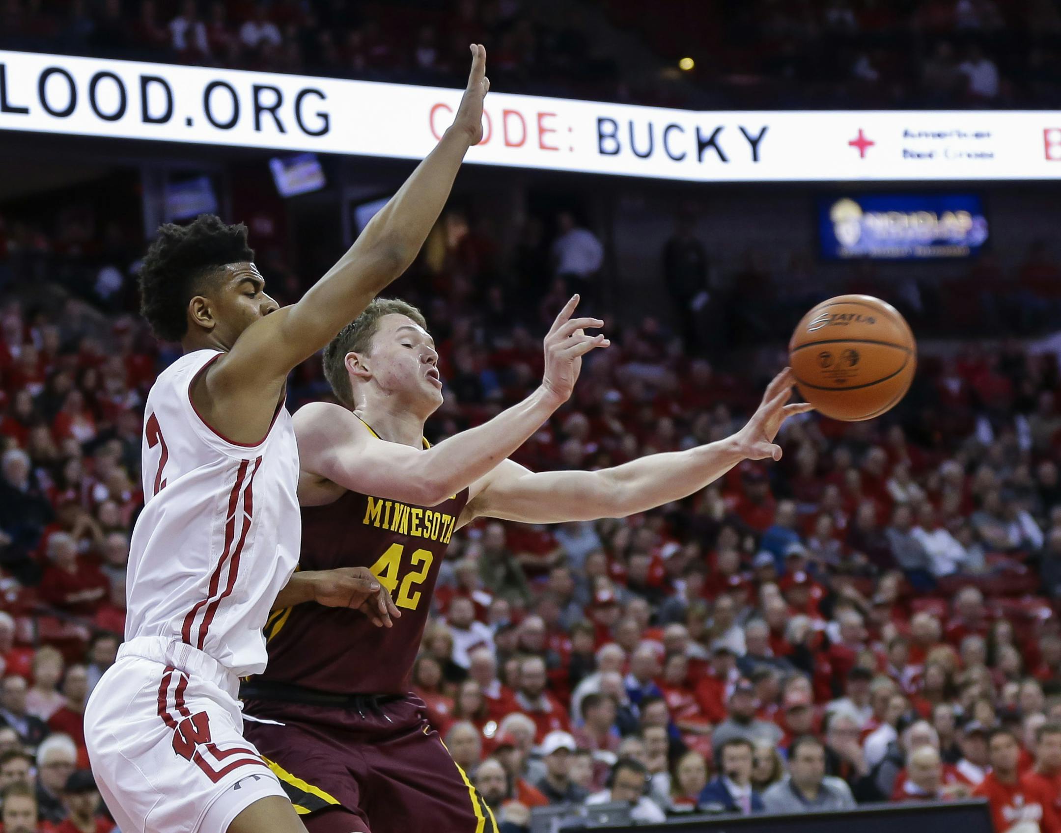 Minnesota's Michael Hurt (42) passes abasing Wisconsin's Aleem Ford (2) during the first half of an NCAA college basketball game Monday, Feb. 19, 2018, in Madison, Wis. (AP Photo/Andy Manis)