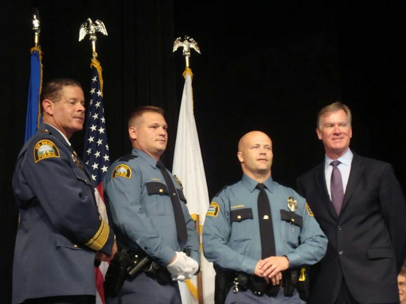 Officer Tim Filiowich (center left) next to his brother Shawn Filiowich (center right) at a ceremony for St. Paul police officers