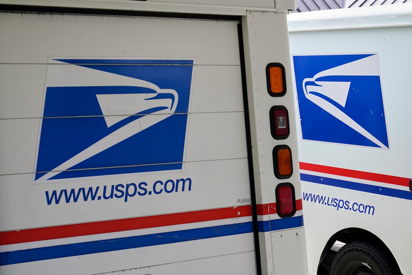 FILE - In this Aug. 18, 2020, photo, mail delivery vehicles are parked outside a post office in Boys Town, Neb. On Friday, Dec. 23, 2022, The Associated Press reported on stories circulating online incorrectly claiming A U.S. Postal Service uniform store was robbed in Tennessee in a scheme to impersonate postal workers and break into homes. (AP Photo/Nati Harnik, File)