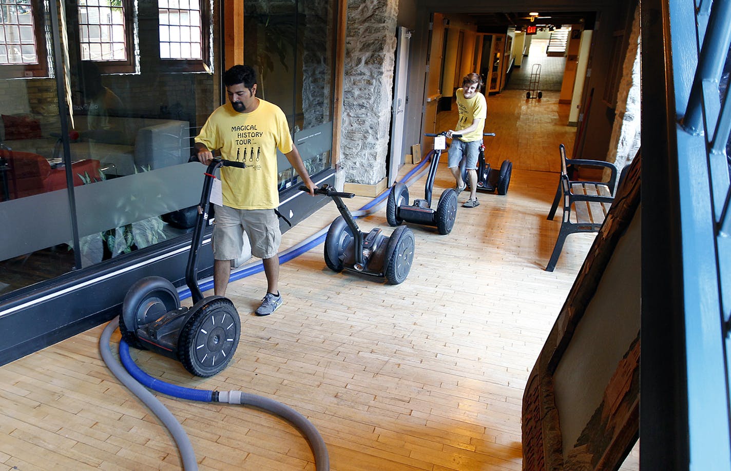 Roop Bassi, left, and Lucas Wiggins remove segways from the damaged Mobile Entertainment, LLC at St. Anthony Main, Thursday, September 5, 2013 in Minneapolis, MN. According to Bill Neuenschwander, the president of the company, losses could total more than $150,000. (ELIZABETH FLORES/STAR TRIBUNE) ELIZABETH FLORES &#x2022; eflores@startribune.com