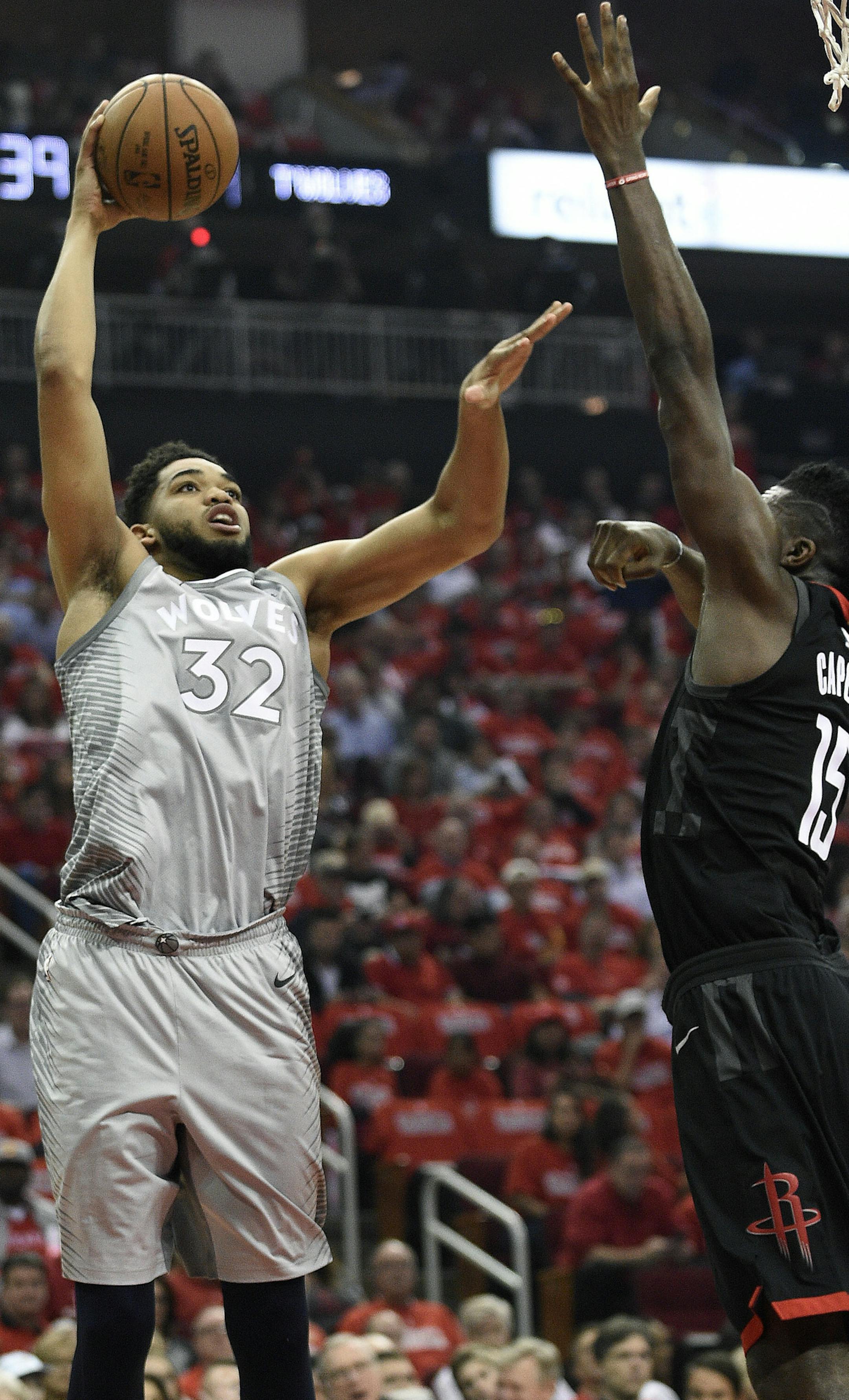 Minnesota Timberwolves center Karl-Anthony Towns (32) shoots as Houston Rockets center Clint Capela defends during the first half in Game 2 of a first-round NBA basketball playoff series Wednesday, April 18, 2018, in Houston. (AP Photo/Eric Christian Smith)