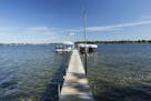 Spray Island, which is listed for $2.75 million, includes a five-bedroom home, guest cottage, and multiple docks for boats to travel across Lake Minne