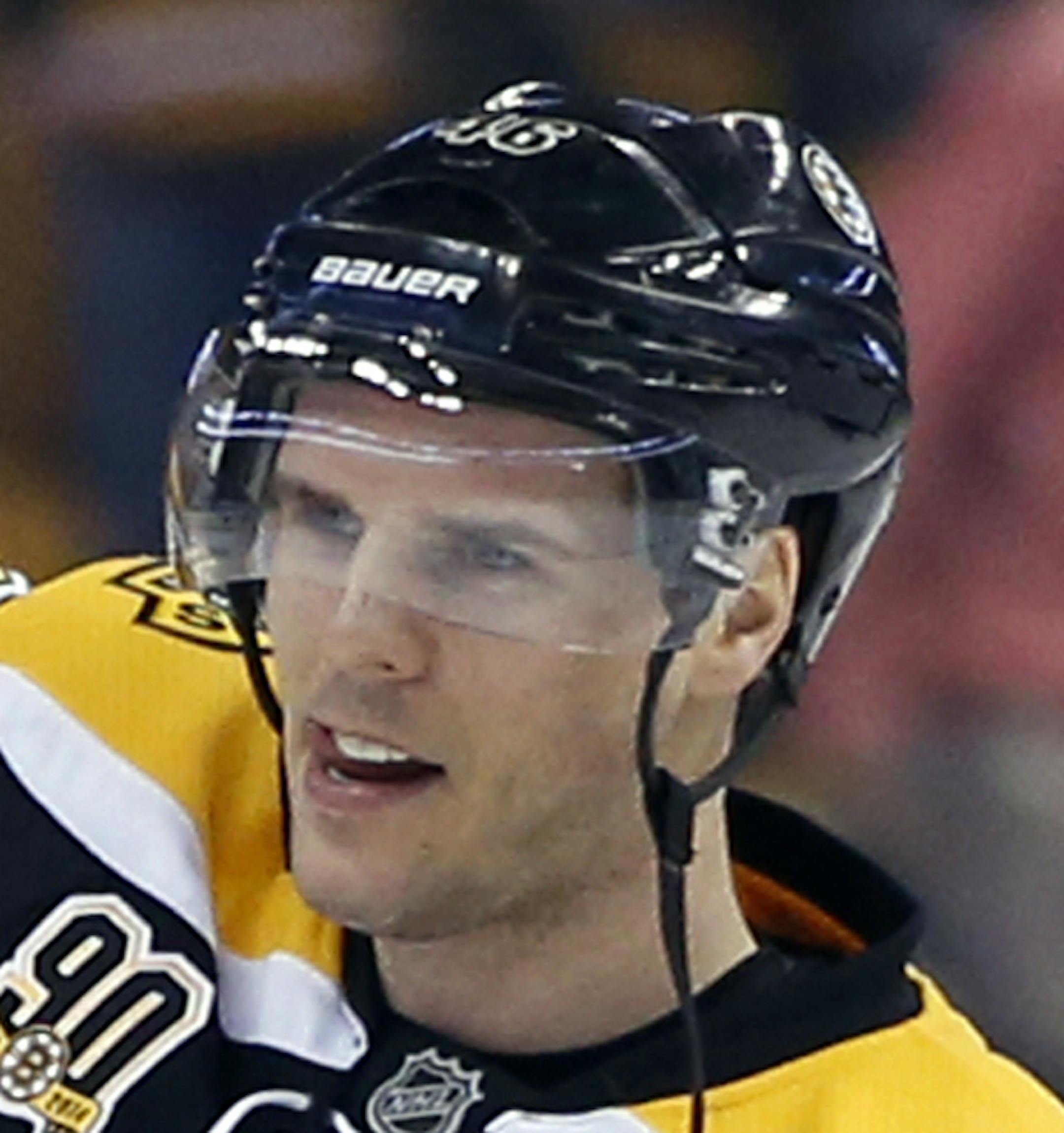 Boston Bruins center David Krejci waves to cheering fans as his hat trick is acknowledged after the Bruins' NHL hockey game against the Florida Panthers in Boston, Tuesday, March 4, 2014. Krejci led the Bruins to a 4-1 victory. (AP Photo/Elise Amendola)