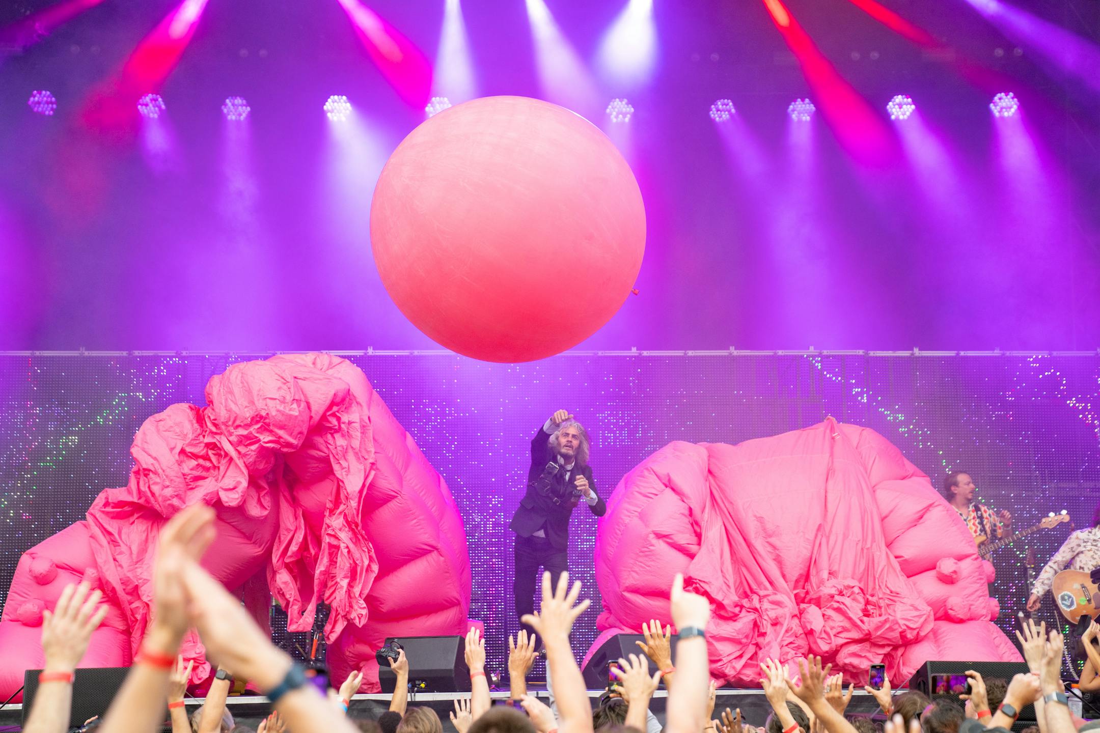 Wayne Coyne, the lead singer of the Flaming Lips, throws a giant balloon into the crowd while he performs with his band at TC Summer Fest Friday, July 14, 2023, at Target Field in Minneapolis.