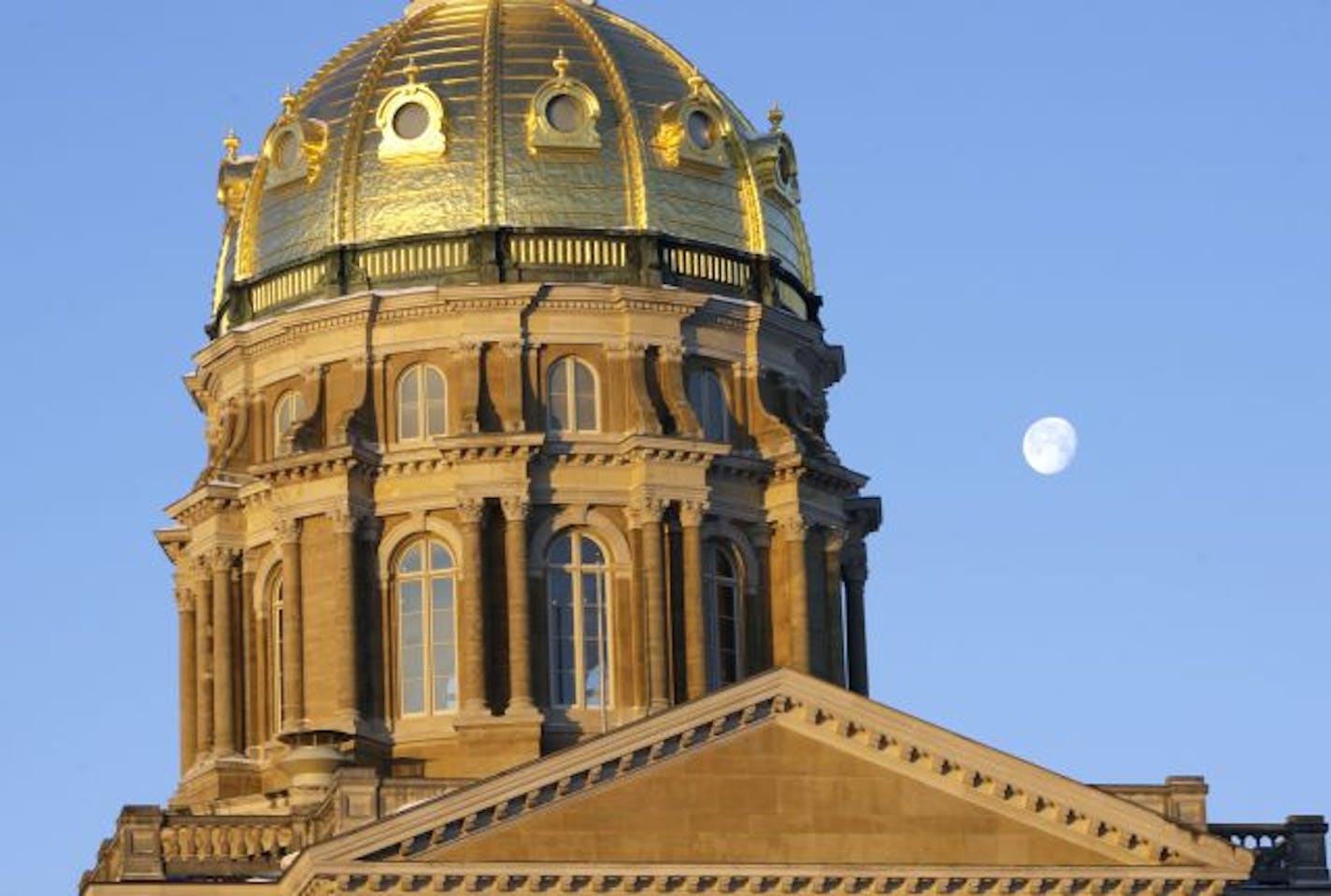 The moon hangs over the Iowa Capitol dome, Tuesday, Jan. 13, 2009.