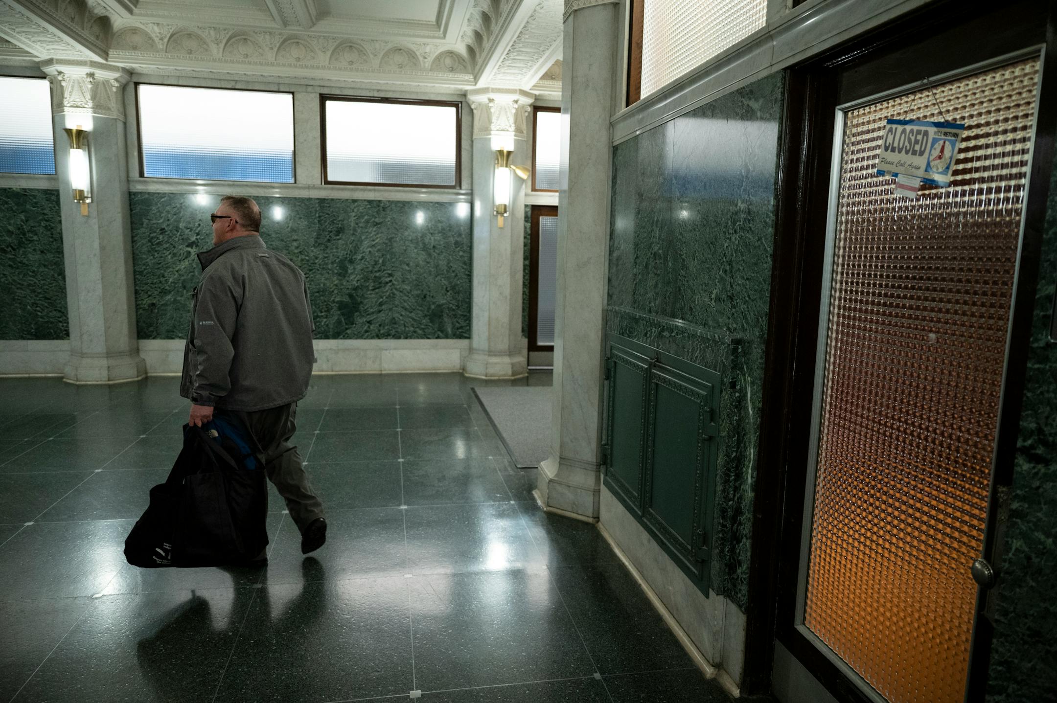 Bob Haddow leaves his shop for the night Wednesday, March 29, 2023 at the Grain Exchange Barbershop in Minneapolis, Minn.. Bob Haddow, veteran barber and philosopher at the Grain Exchange Barbershop is out on Friday, thanks to remodeling of the 120-year-old building lobby by the Grain Exchange owner.
