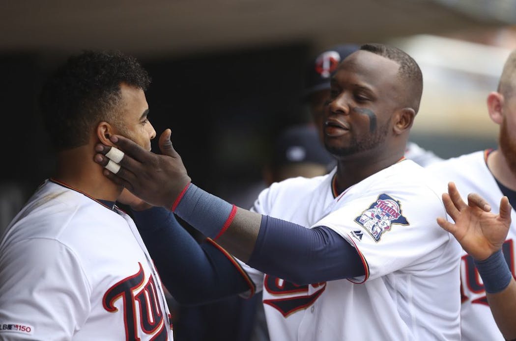 Miguel Sano congratulates Nelson Cruz on his 40th home run of the season, and his 400th career homer. on September 22.