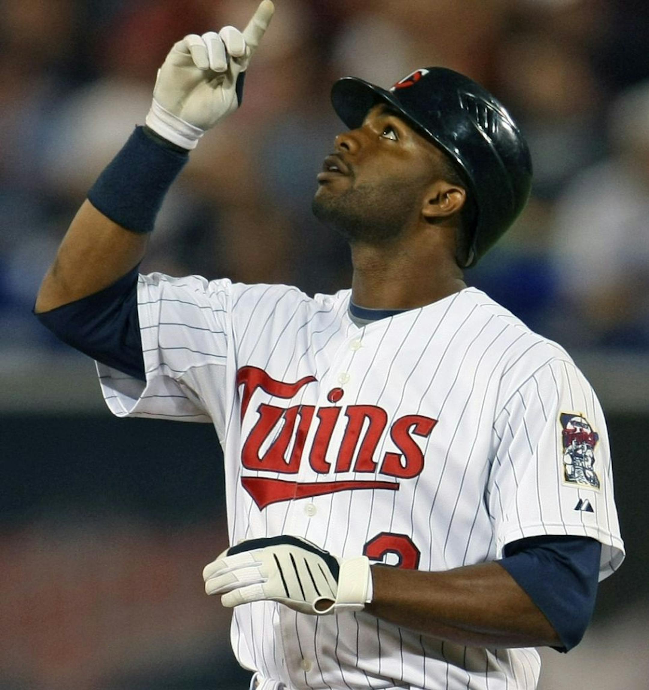 Minnesota Twins vs LA Angels. (left to right) Twins Denard Span pointed to the heavens after doubling, as Angles Bobby Abreu bobbled his hit in the outfield. The double scored Nick Punto in the fourth inning.
