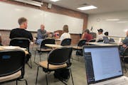 David Schultz, second from left, led a session of the American Government and Politics class at Hamline University last Friday, as a student’s lapto