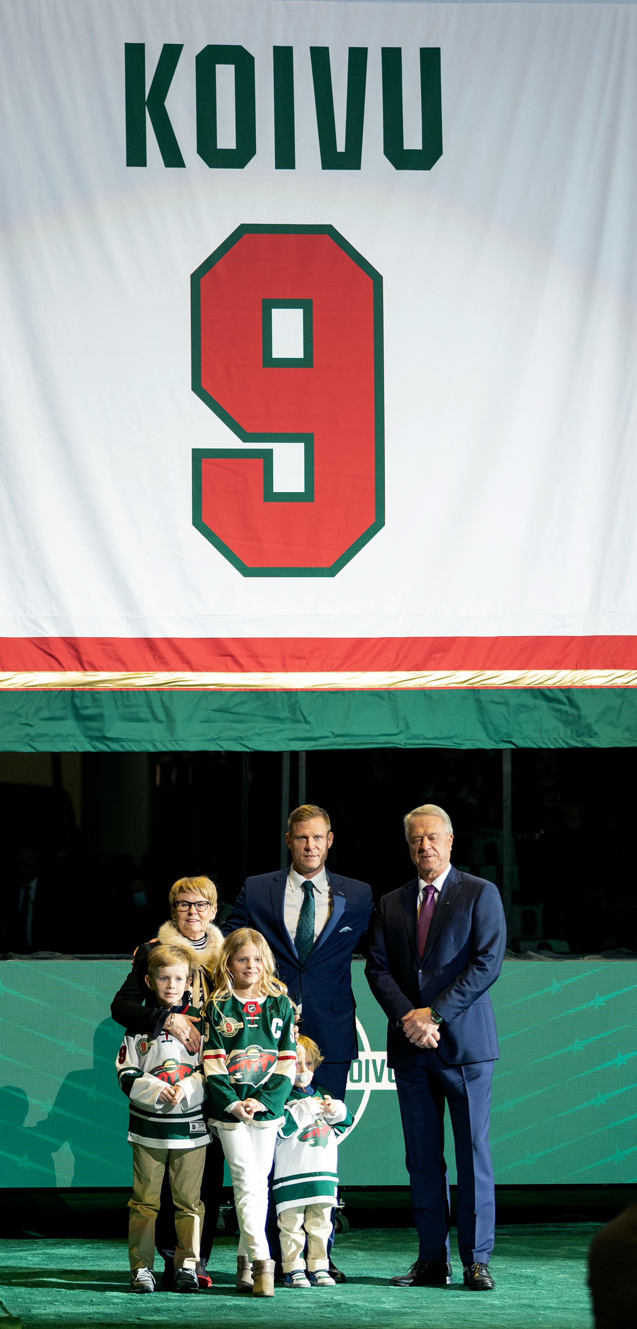 Mikko Koivu poses for photos with his family during a ceremony to retire his number.