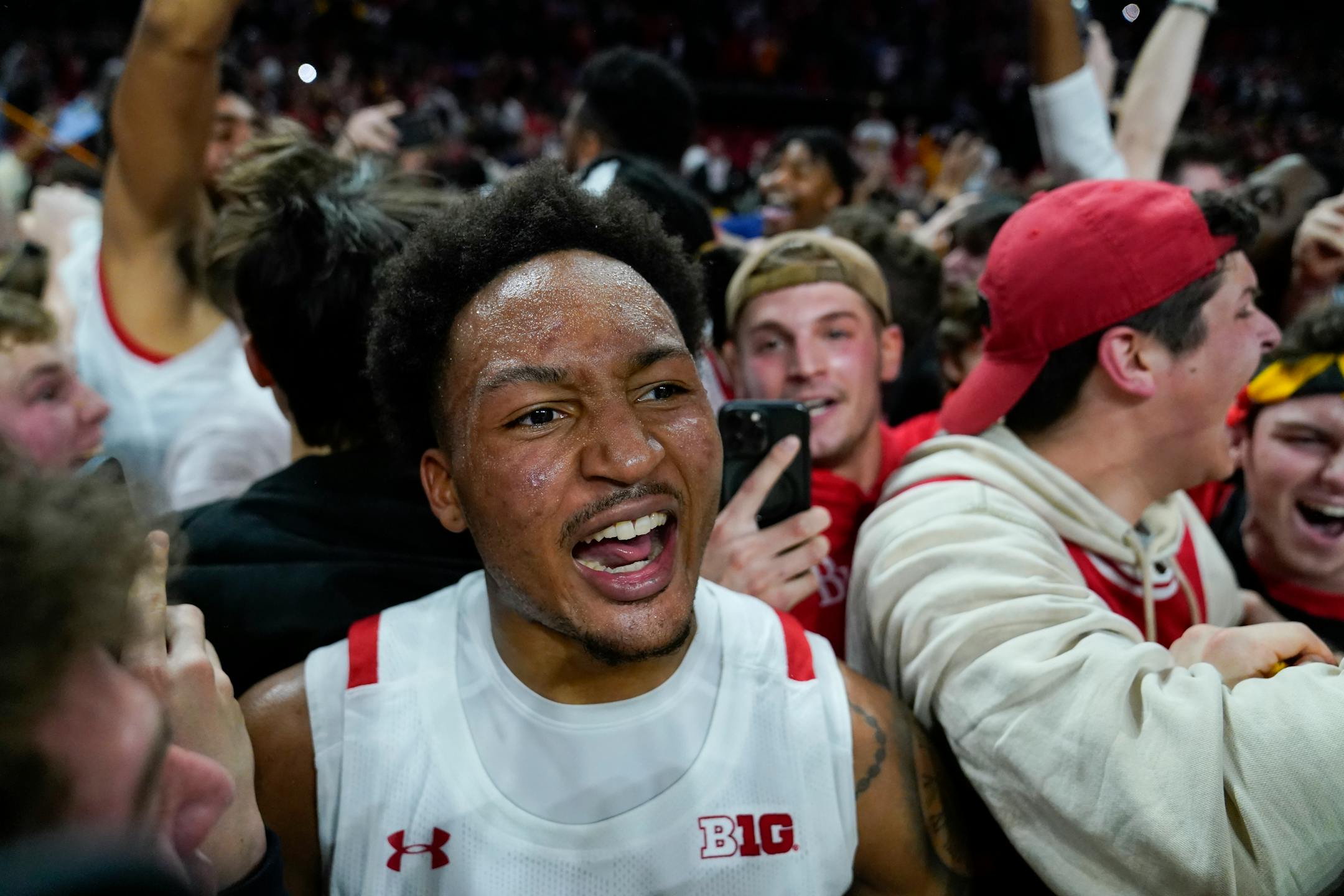 Maryland guard Jahmir Young reacts as students rush the court after Maryland defeated Purdue 68-54 during an NCAA college basketball game, Thursday, Feb. 16, 2023, in College Park, Md. (AP Photo/Julio Cortez)