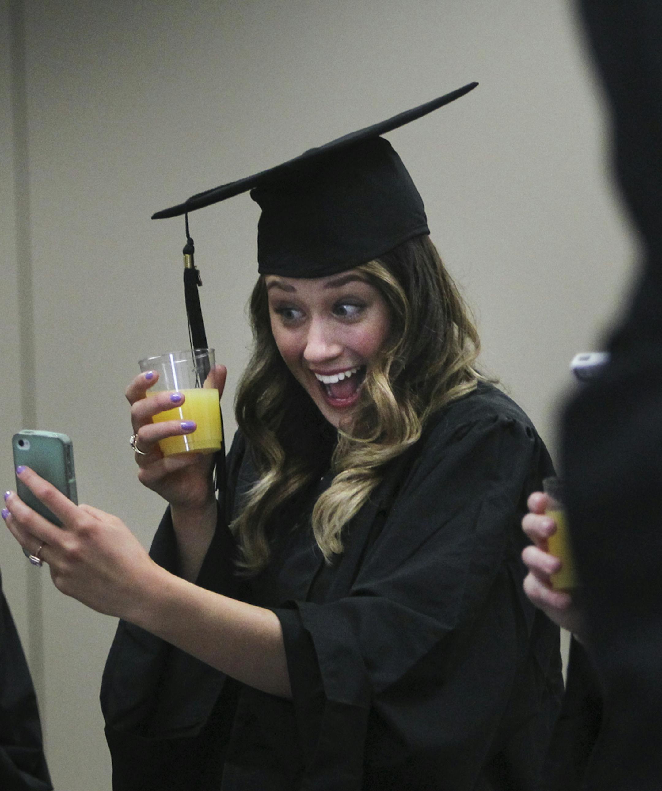Prior to the graduation ceremony, University of Minnesota, Rochester student Lauren Smith of Allen Park, MI, takes an iPhone self portrait at the Mayo Civic Center Saturday, May 18, 2013 in Rochester, MN.](DAVID JOLES/STARTRIBUNE) djoles@startribune The first-ever class of undergrads at the University of Minnesota, Rochester graduate this weekend. When they began as freshmen, there were no dorms, no upperclassmen, no mascot.**Lauren Smith,cq