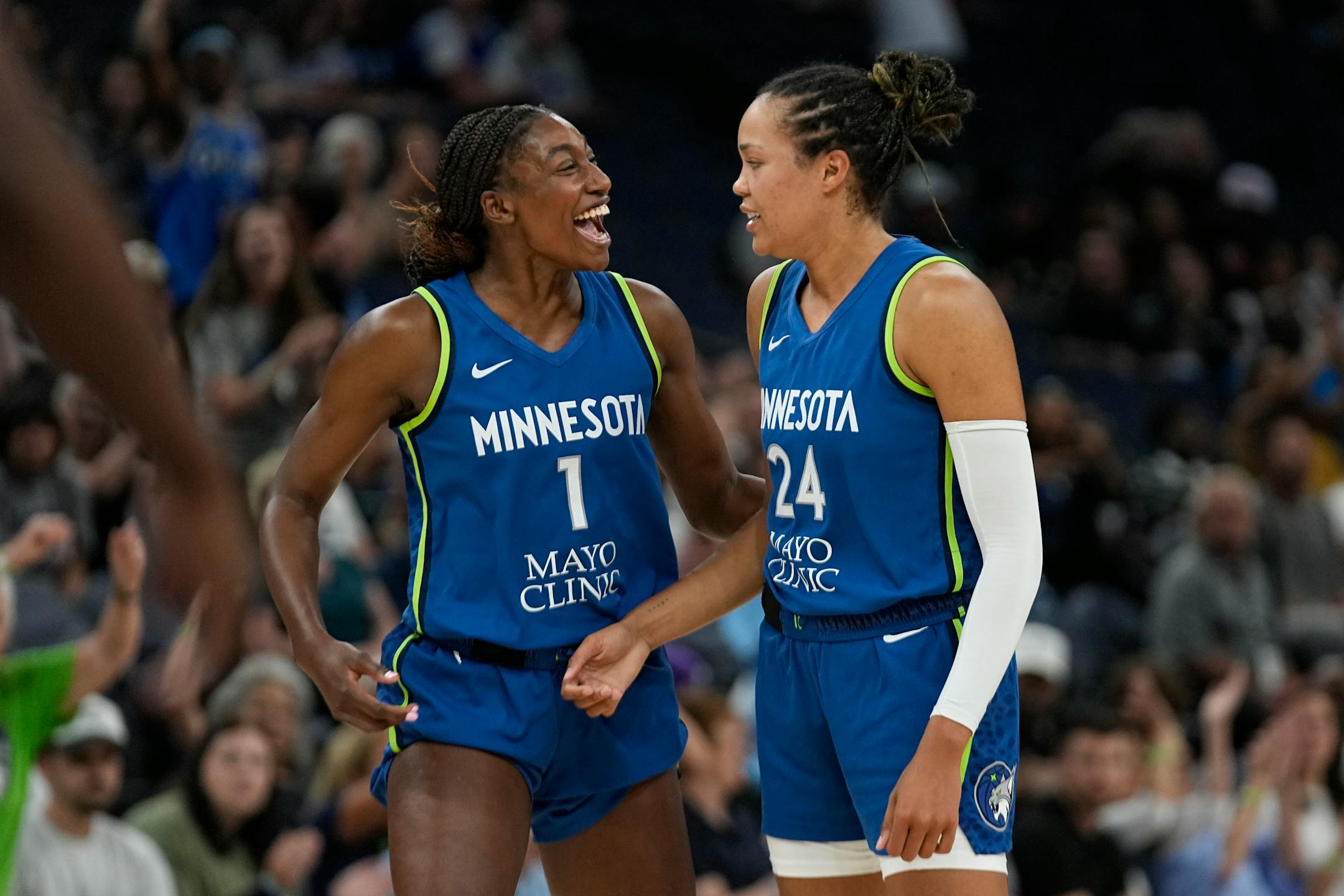 Minnesota Lynx forward Napheesa Collier (24), right, celebrates with guard Diamond Miller (1) after making a basket during the second half of a WNBA basketball game against the Seattle Storm, Tuesday, June 27, 2023, in Minneapolis. (AP Photo/Abbie Parr)