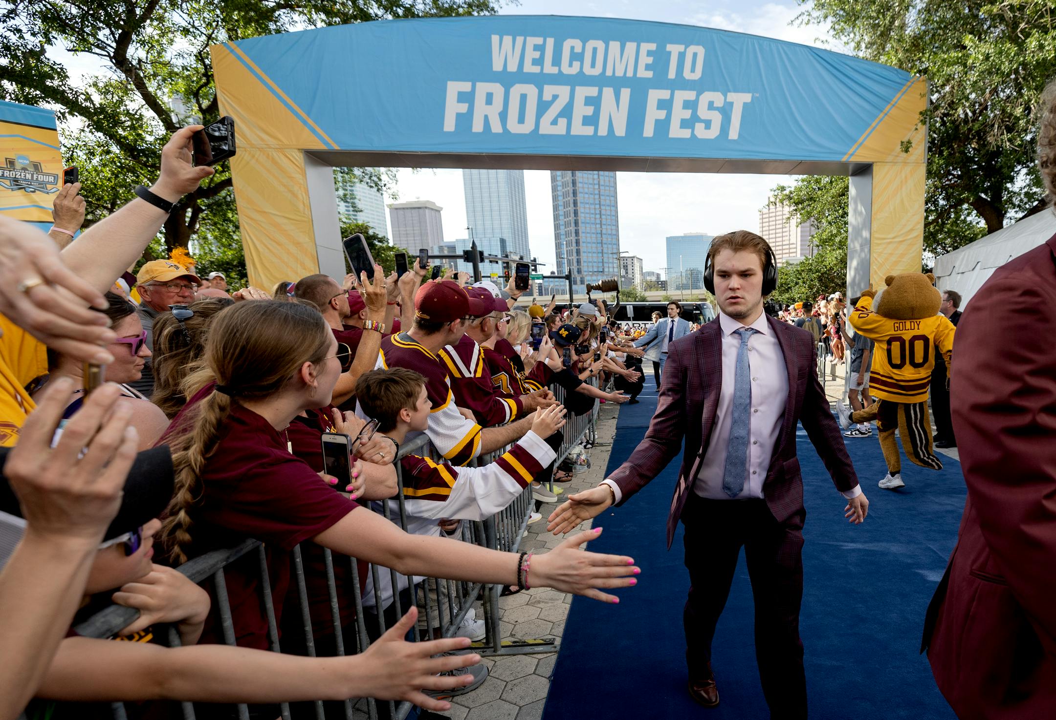 Minnesota Gophers players are greeted by fans as they arrive.