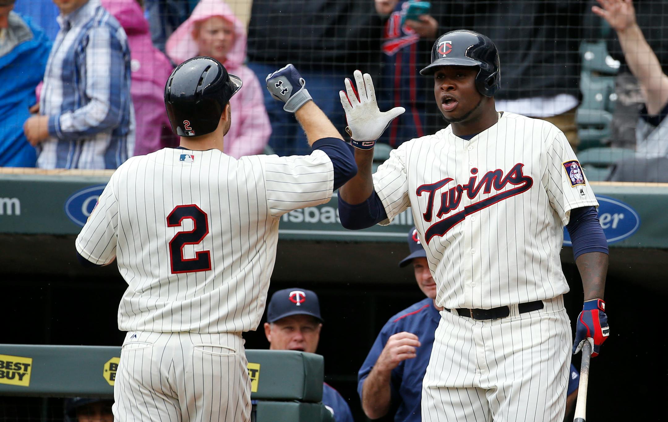 Miguel Sano, right, congratulates teammate Brian Dozier on Dozier's solo home run off Kansas City Royals starting pitcher Dillon Gee.
