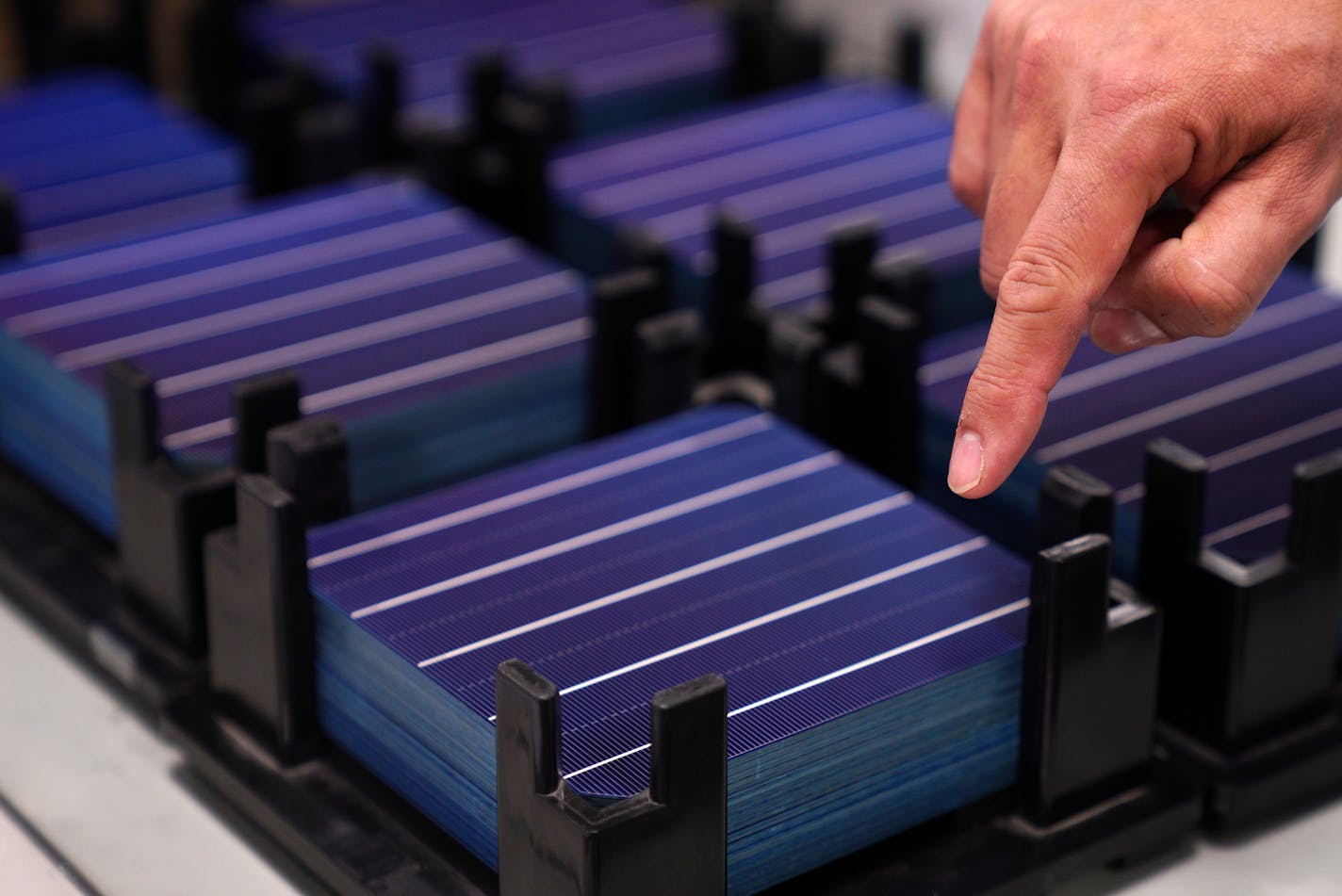 This stack of individual solar cells are assembled to make up a larger panel at Heliene Inc. in Mountain Iron, Minn.