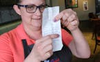 Shannon Vargas, a waitress at The Original Pancake House, holds up the receipt where she received a $2,020 tip, on Friday, Jan. 17, 2020, in Oak Lawn,