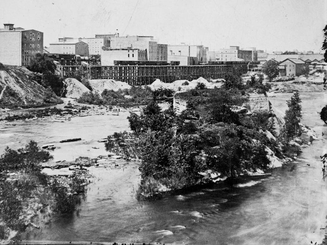 Spirit Island and the growing Mill District in 1876.