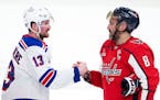 Rangers left wing Alexis Lafrenière (13) shakes hands with Capitals left wing Alex Ovechkin (8) following New York's sweep Sunday.