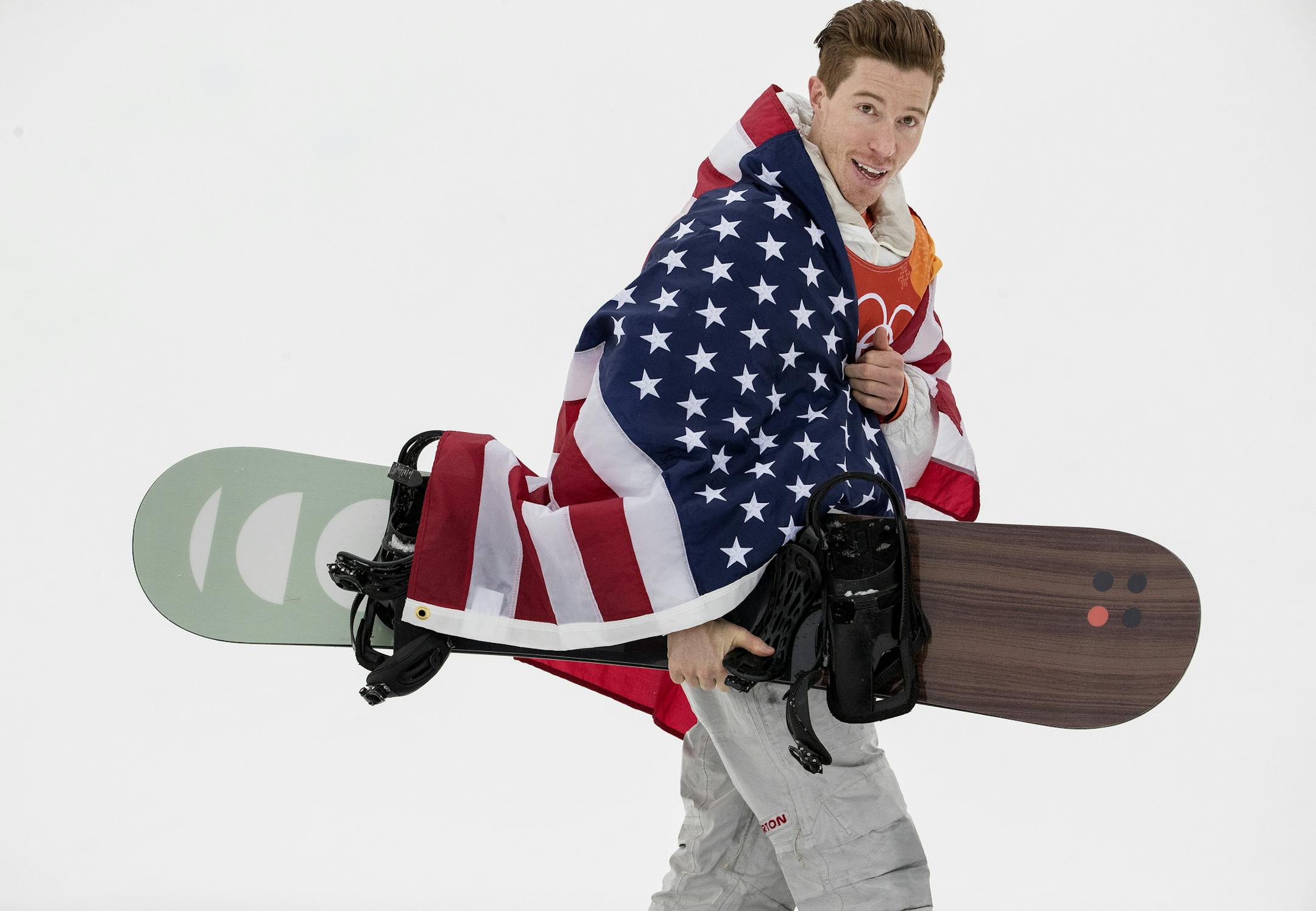 Shaun White continued Team USA's dominance in snowboarding events at the Olympic Winter Games PyeongChang 2018 by claiming the gold medal in men's snowboard halfpipe Wednesday morning at Phoenix Snow Park. It is the 100th gold medal won by Team USA in Olympic Winter Games history. The leader after first runs with a score of 94.25, White was displaced by Japan's Ayumu Hirano, who upped the ante with a second run of 95.25. That set up the drama of White's final run, which he nailed, soaring to a 9