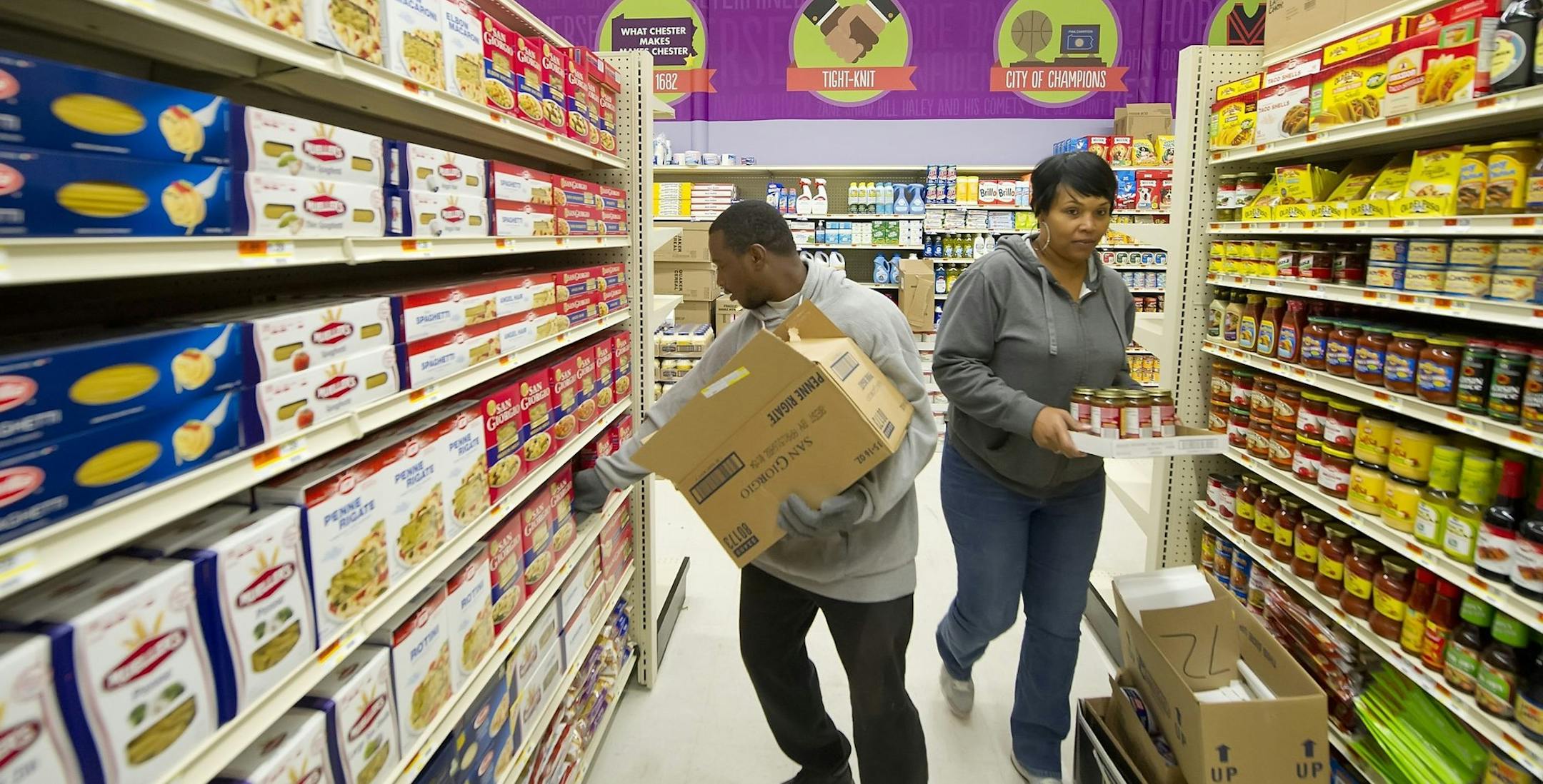Deric Carter, left, and Cynthia Adams stock shelves at the new Fare & Square supermarket, a non-profit store, in Chester, Pennsylvnia, on September 24, 2013. (Clem Murray/Philadelphia Inquirer/MCT)