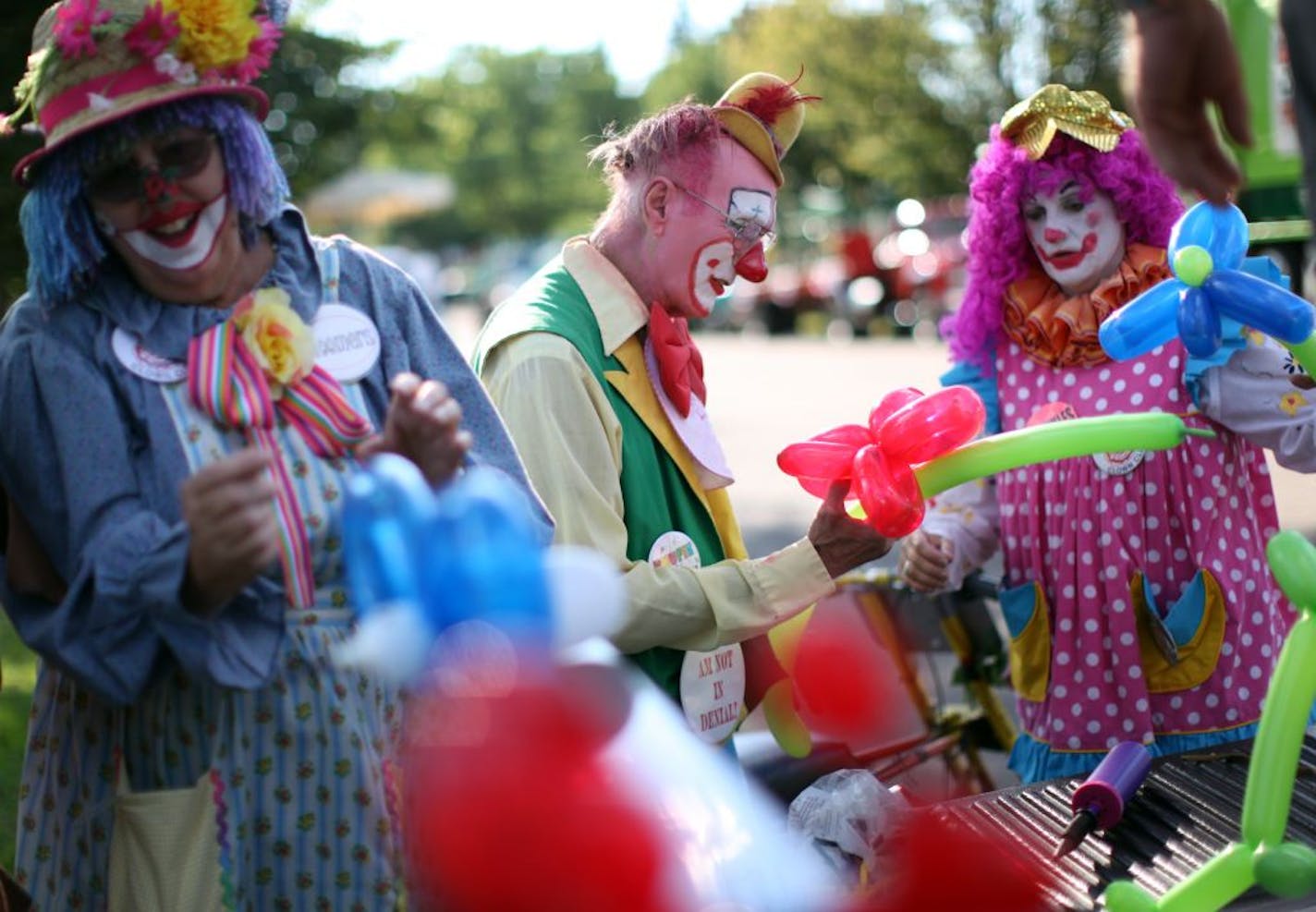 Frank Mitchell, center, made balloon animals with other clowns from the St. Paul Clown Club as they prepared their truck for the Stockyard Days Parade.