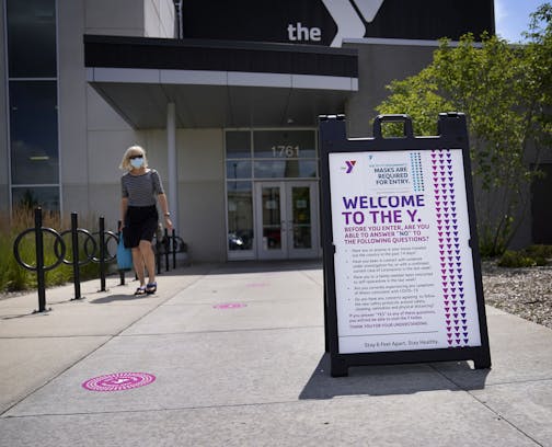 The Midway YMCA was one of two of the first YMCAs to reopen June 10 at 25% capacity. Here, COVID-19 rules are posted outside of the Midway YMCA for all entering Friday.