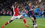 Reims' Romain Metanire (left), acquired by Minnesota United, battled Paris-Saint-Germain's Edinson Cavani during a French League One match Sept. 26 in