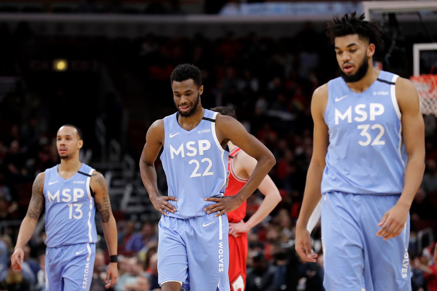 Timberwolves forward Andrew Wiggins reacts as he walks with guard Shabazz Napier, left, and center Karl-Anthony Towns after missing a basket during the second half