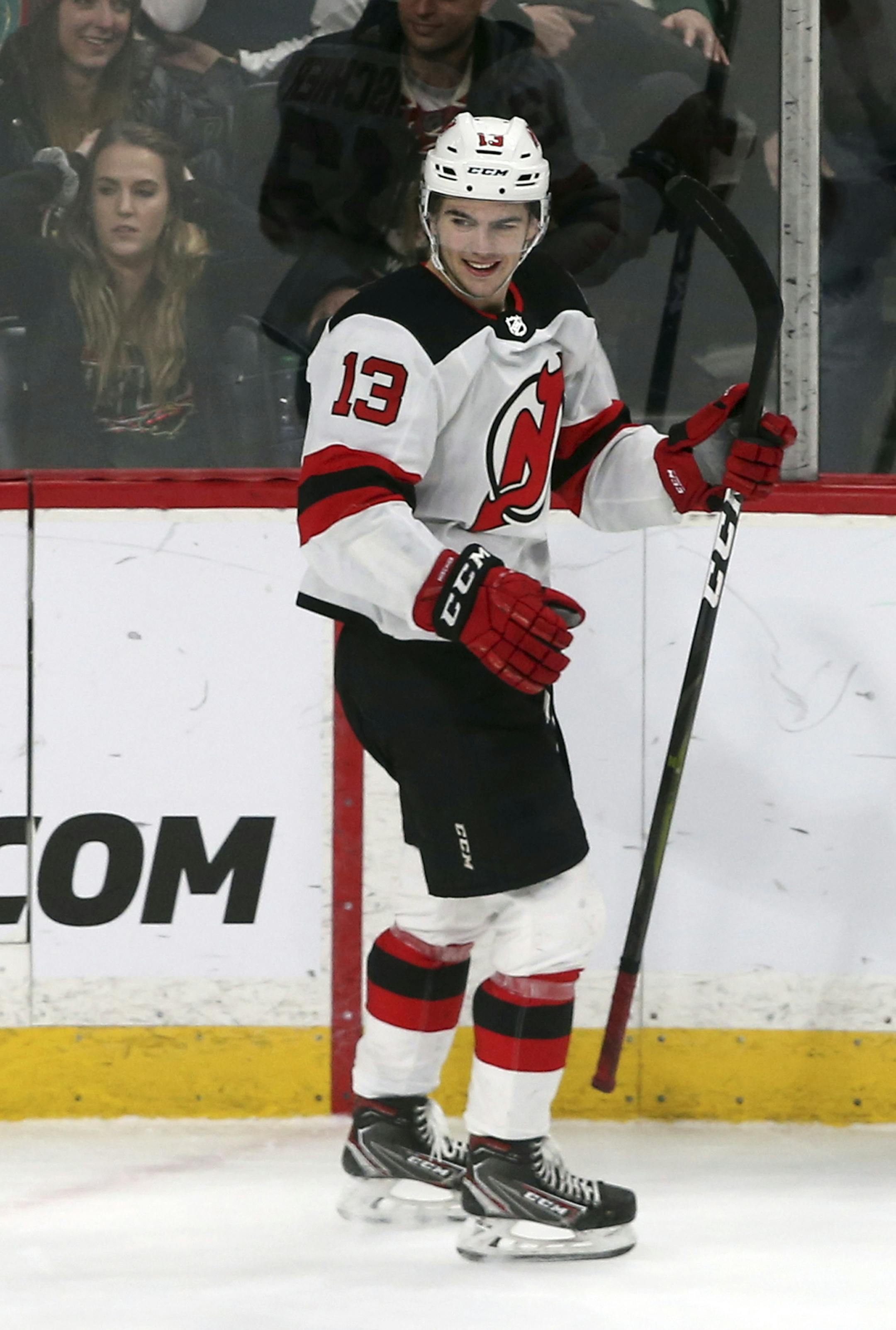 New Jersey Devils' Nico Hischier, of Switzerland, smiles after scoring in overtime against Minnesota Wild goalie Devan Dubnyk during an NHL hockey game Friday, Feb.15, 2019, in St. Paul, Minn. The Devils won 5-4. (AP Photo/Jim Mone)