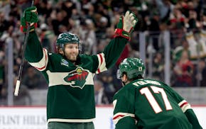Ryan Hartman (38) of the Wild celebrates a goal with Marcus Foligno (17) in the first period against the Vegas Golden Knights at Xcel Energy Center in