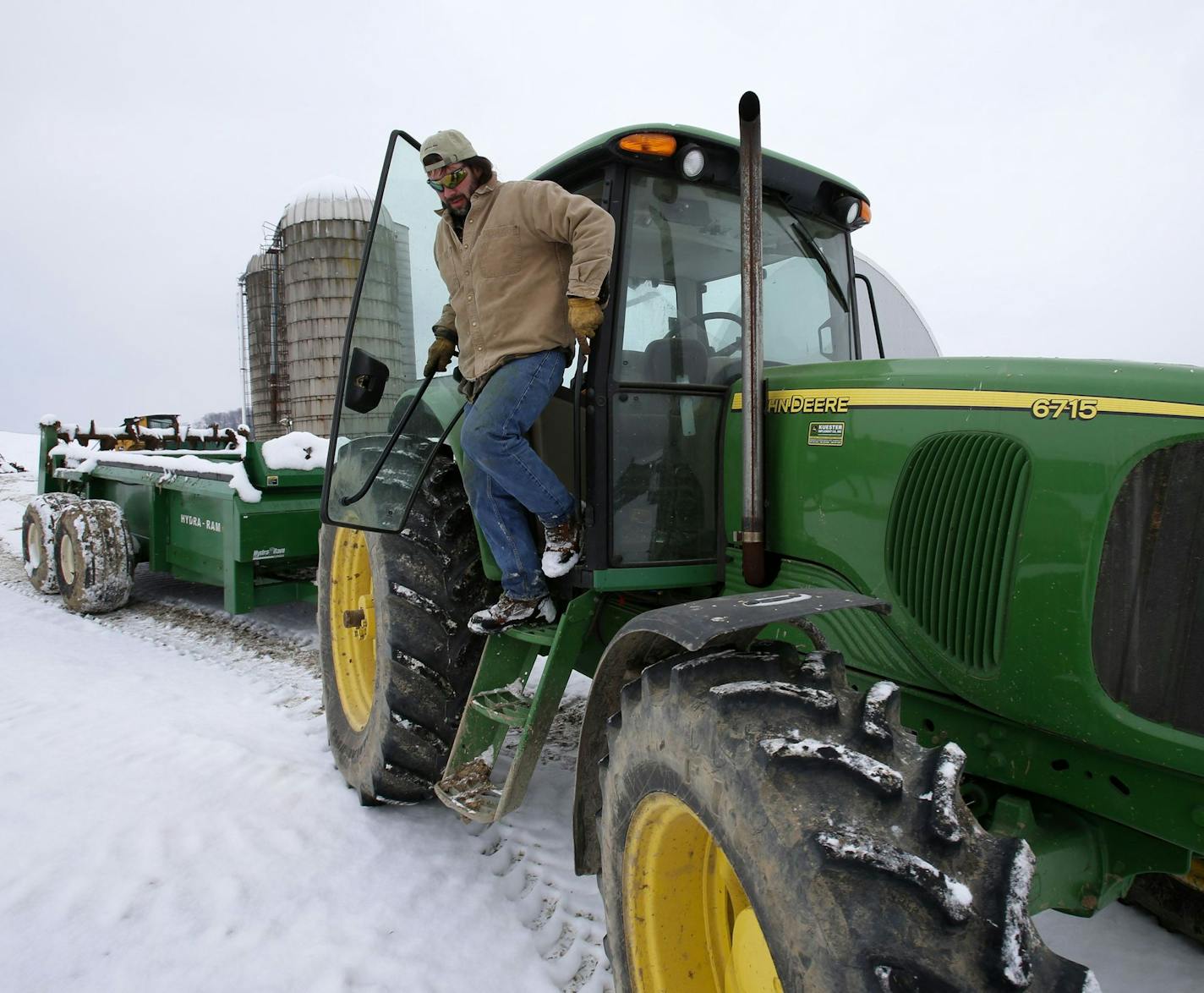 FILE - In this Jan. 26, 2013 photo, Shawn Georgetti climbs out of his John Deere tractor on his 167-acre family dairy farm in Avella, Pa. Small businesses are close to getting a permanent half-million-dollar tax break when they buy equipment like cars, computers and machinery, but tax pros say owners should crunch some numbers before claiming the big deduction.(AP Photo/Gene J. Puskar) ORG XMIT: NY126