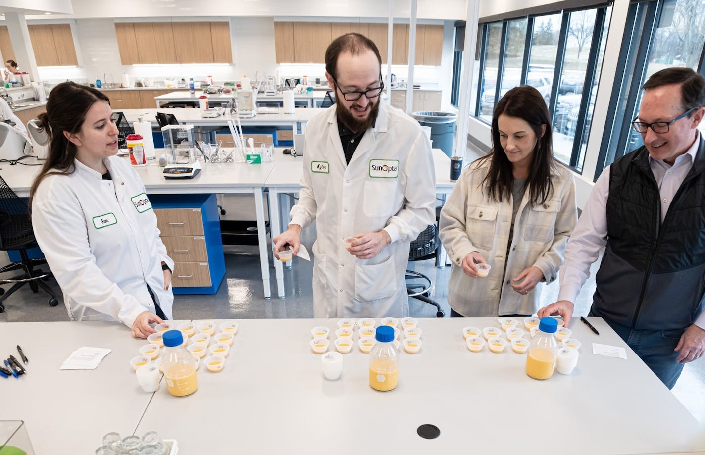 SunOpta CEO Joe Ennen, right, watched as food scientists evaluated samples of a pumpkin oat beverage, Tuesday, March 29, 2022, Eden Prairie, Minn. ] GLEN STUBBE • glen.stubbe@startribune.com