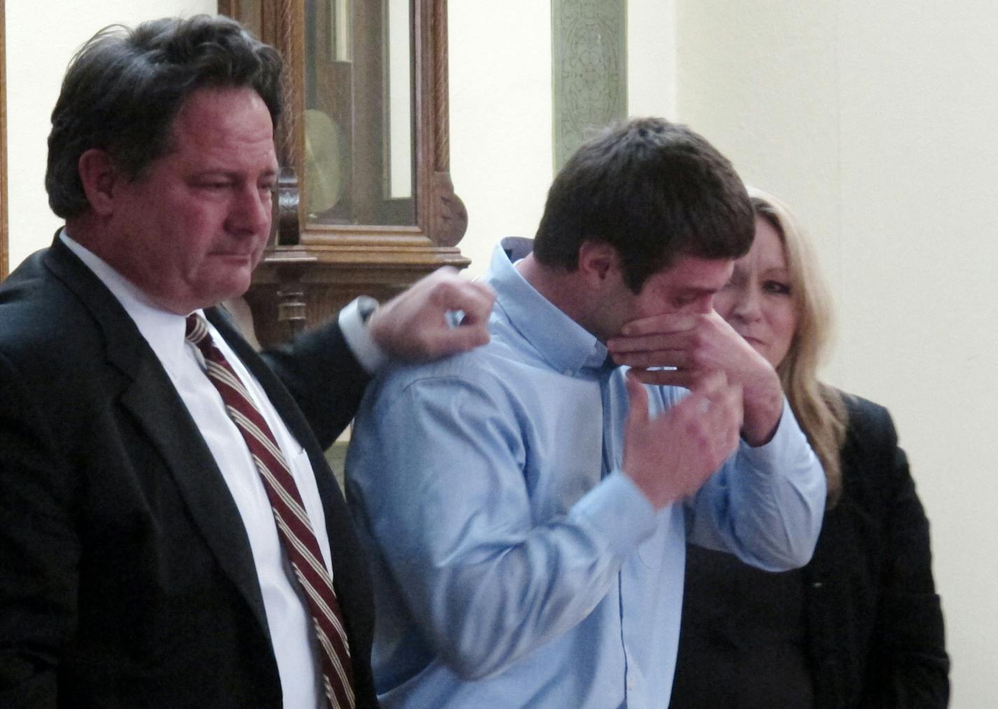 Former University of Montana quarterback, Jordan Johnson, center, reacts after being acquitted of rape charges during his trial Friday March 1, 2013 in Missoula, Mont. With Johnson are his attorneys, David Paoli and Kirsten Pabst. The accusations against Johnson, 20, have drawn much attention in Montana, where UM football is the top sports attraction. Jurors deliberated for less than two hours. (AP Photo/Matt Gouras) ORG XMIT: RPMG102