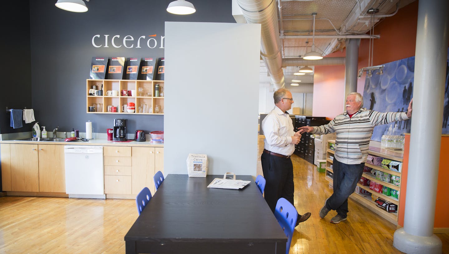 Chuck Gross, right, the owner of the Savoie Building in the North Loop, talks to tenant Andrew Eklund of Ciceron inside his building on Monday, April 20, 2015. ] LEILA NAVIDI leila.navidi@startribune.com /