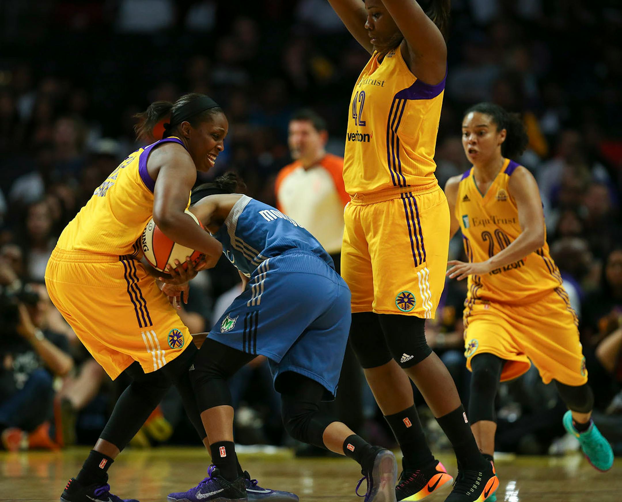 Los Angeles Sparks guard Chelsea Gray (12) took the ball away from Minnesota Lynx guard Renee Montgomery (21) in the fourth quarter as she and Los Angeles Sparks center Jantel Lavender (42) guarded her.