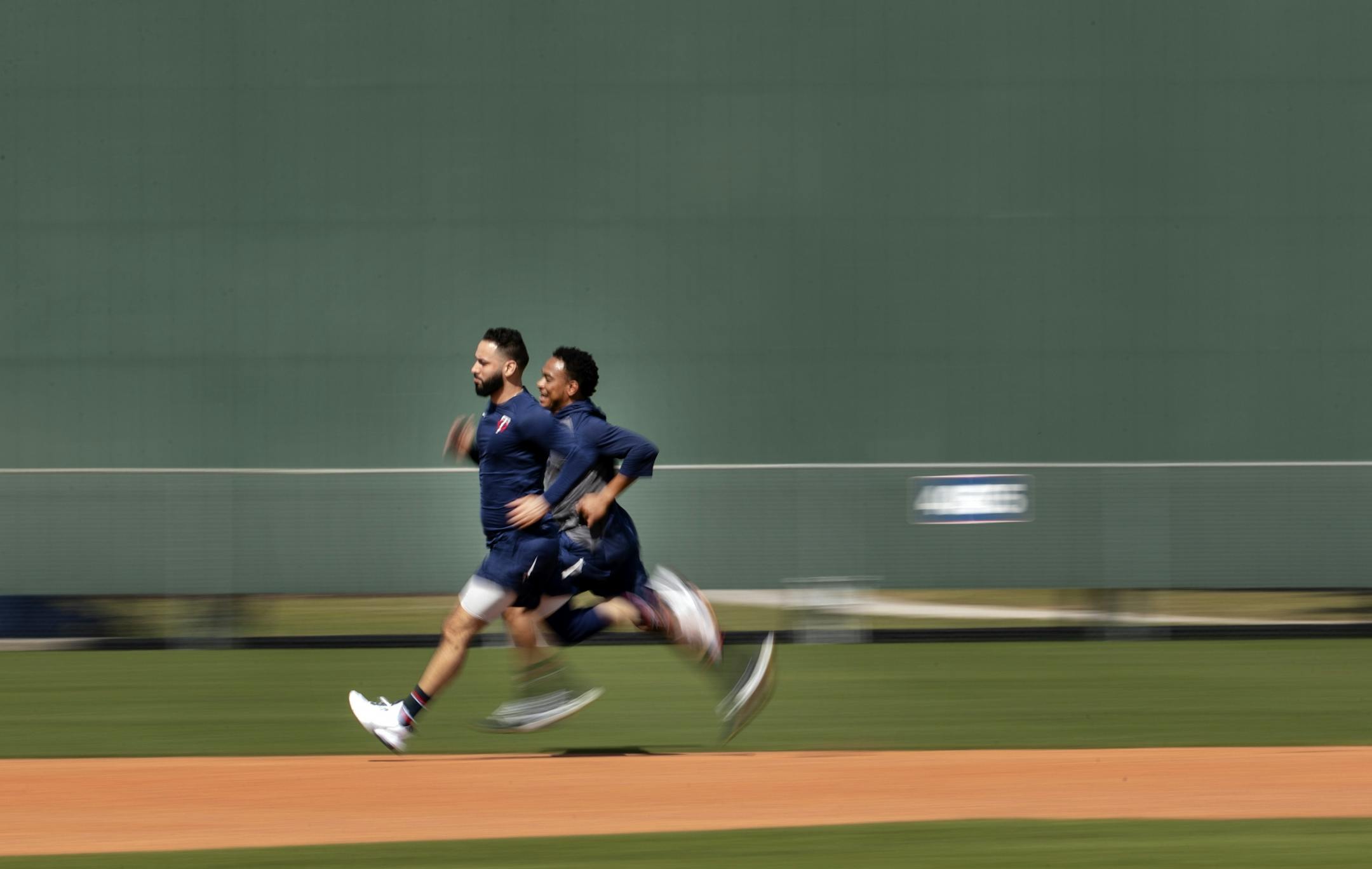 Minnesota Twins players Marwin Gonzalez and Jorge Polanco ran during a workout on Tuesday.