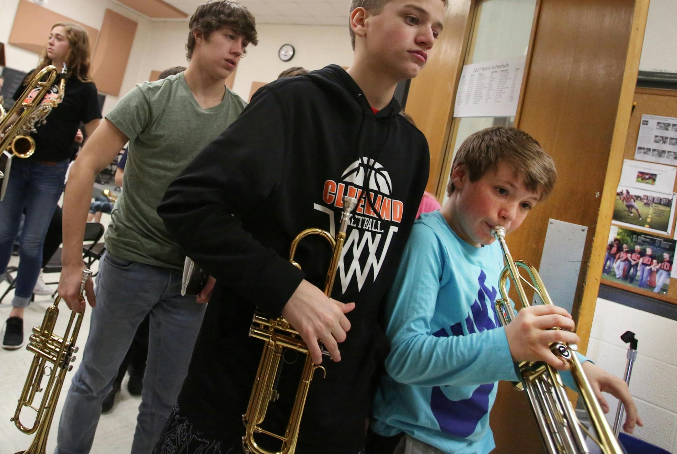 Eighth grader Aarin Clough, right, gets in some additional trumpet work after afternoon band practice at Cleveland Public School, where almost 90 percent of the school's students play in band, chats with students before a lunch hour jazz practice Tuesday, Feb. 21, 20117, in Cleveland, MN.