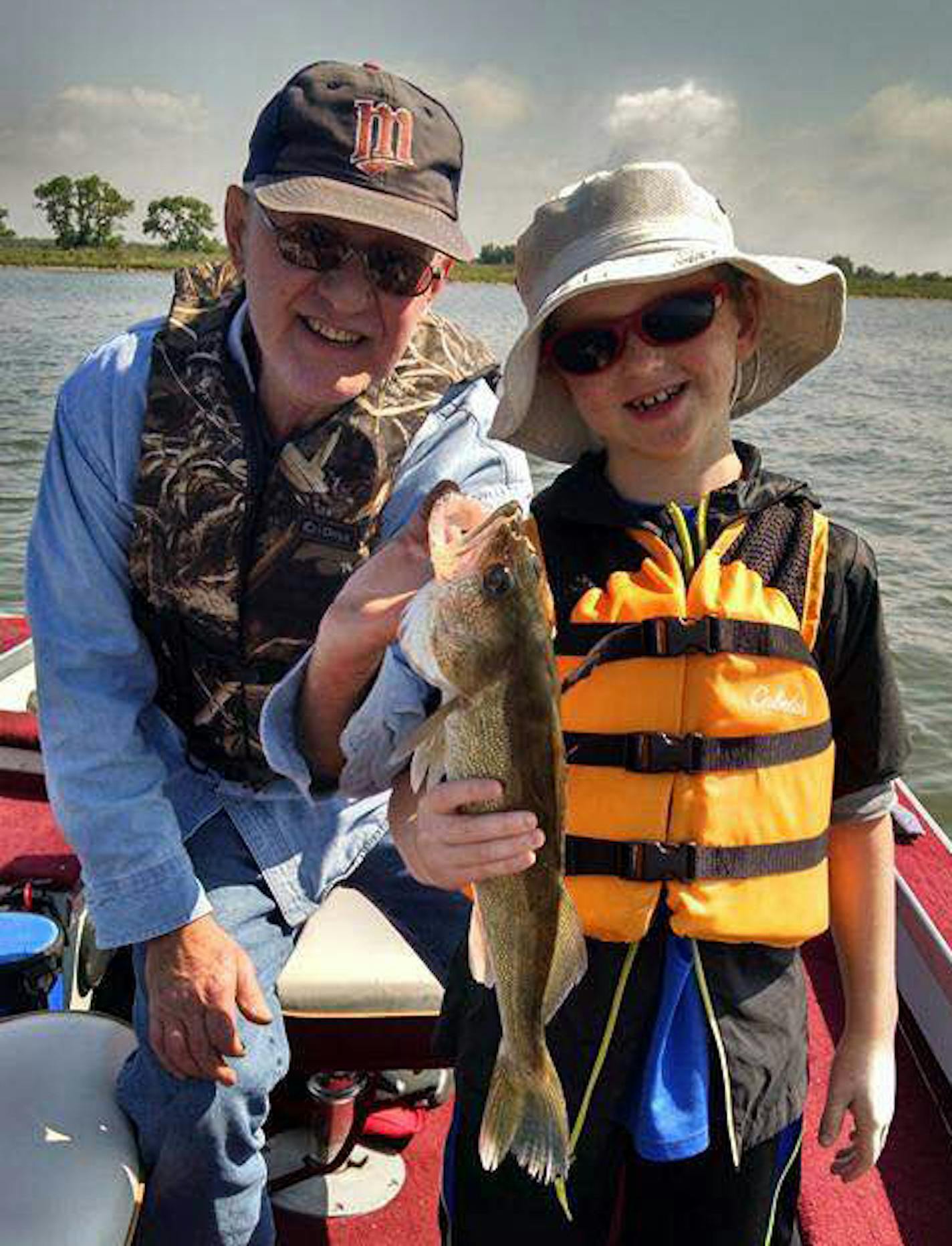 8-year-old Alan Groskreutz, of Eagan, with the help of his uncle Clarence Miller, caught his first walleye -- a 21-incher -- on Lac qui Parle Lake on May 29 .