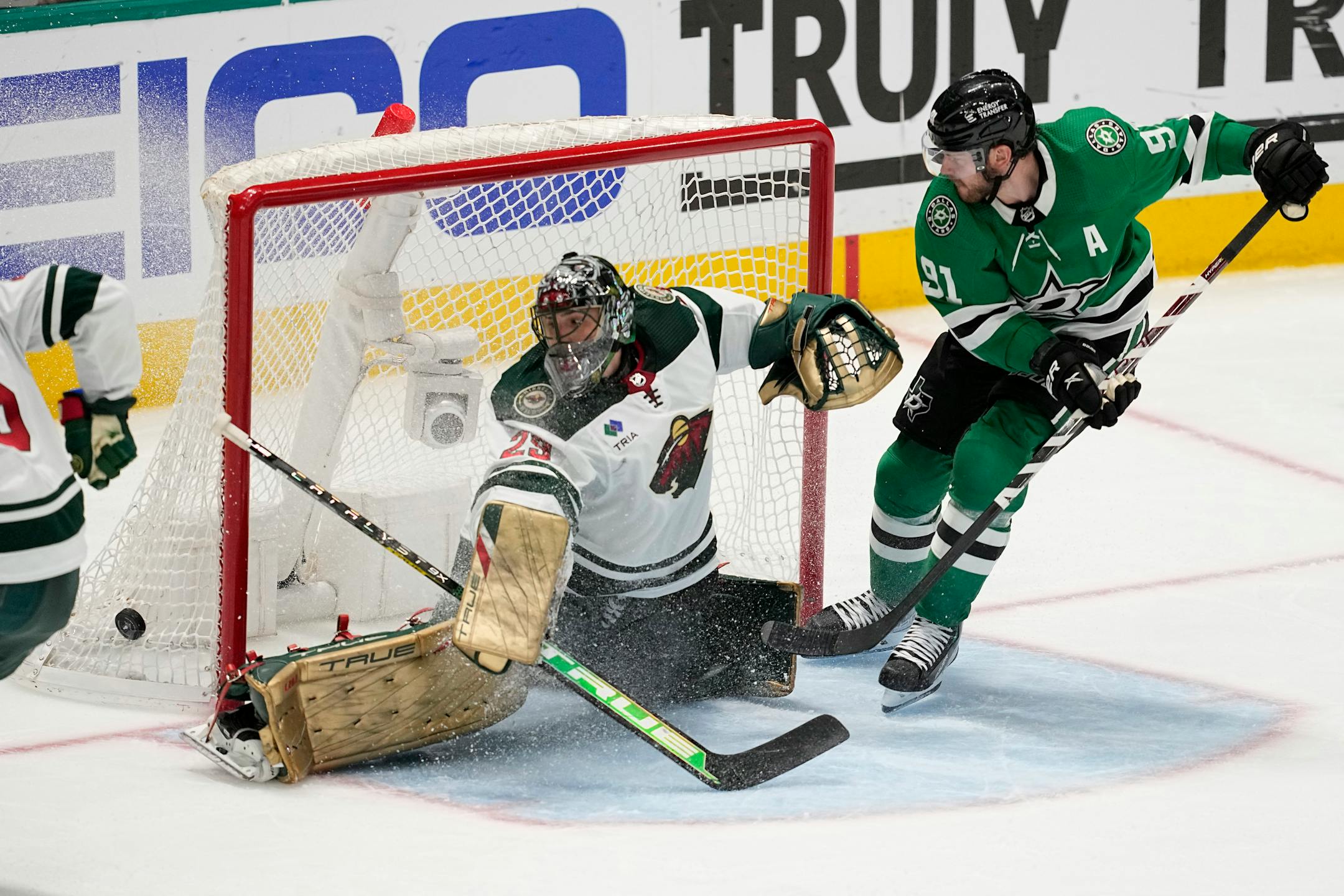 Minnesota Wild goaltender Marc-Andre Fleury (29) deflects a shot as Dallas Stars center Tyler Seguin, right, pressures the net in the third period.