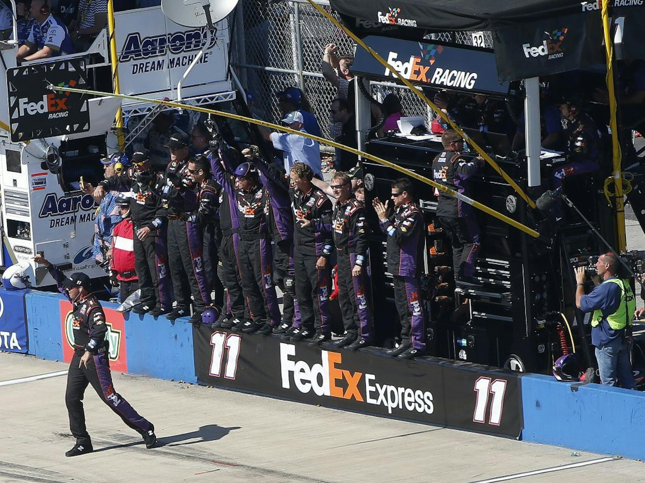 Denny Hamlin's crew cheers as Hamilin wins the NASCAR Aaron's 499 Sprint Cup series auto race at Talladega Superspeedway, Sunday, May 4, 2014, in Talladega, Ala.